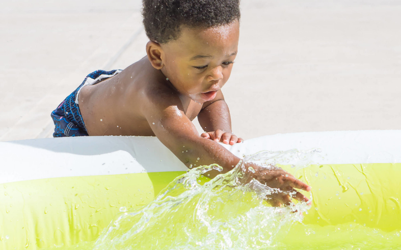 Child playing in wading pool